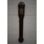 A GEORGE IV MAHOGANY AND INLAID CISTERN STICK BAROMETER, with carved fretwork above a single door