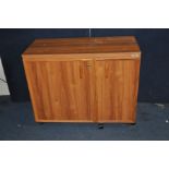 A HORN SEWING FURNITURE SEWING CUPBOARD with two doors enclosing shelves and caddies, flip over lids