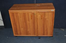 A HORN SEWING FURNITURE SEWING CUPBOARD with two doors enclosing shelves and caddies, flip over lids