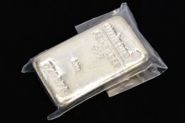 A 500 GRAM SILVER INGOT, signed 'Umicore Feinsilber 999 500g, serial number 523674', within a sealed