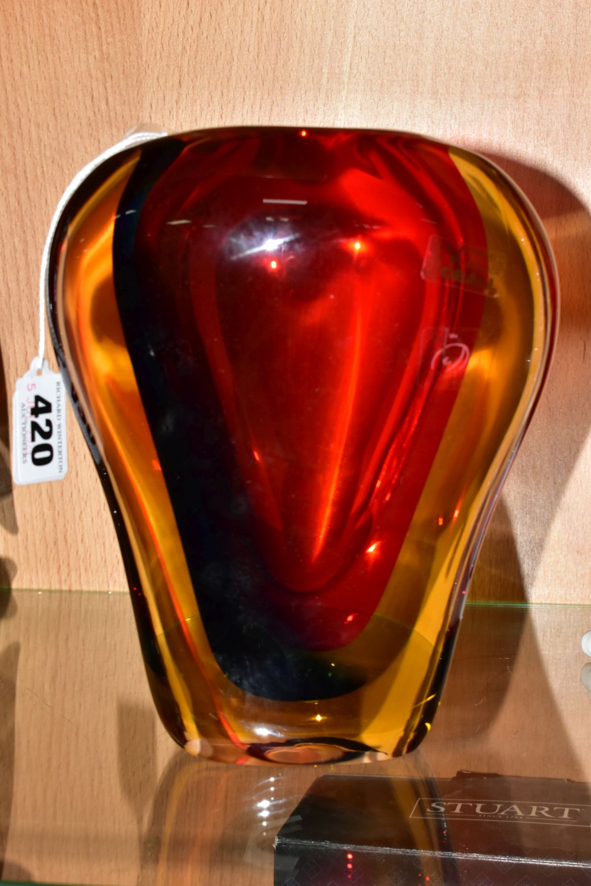 A MURANO OBALL TRI COLOUR CASED GLASS VASE, in red, blue and amber, bears betched signature to the