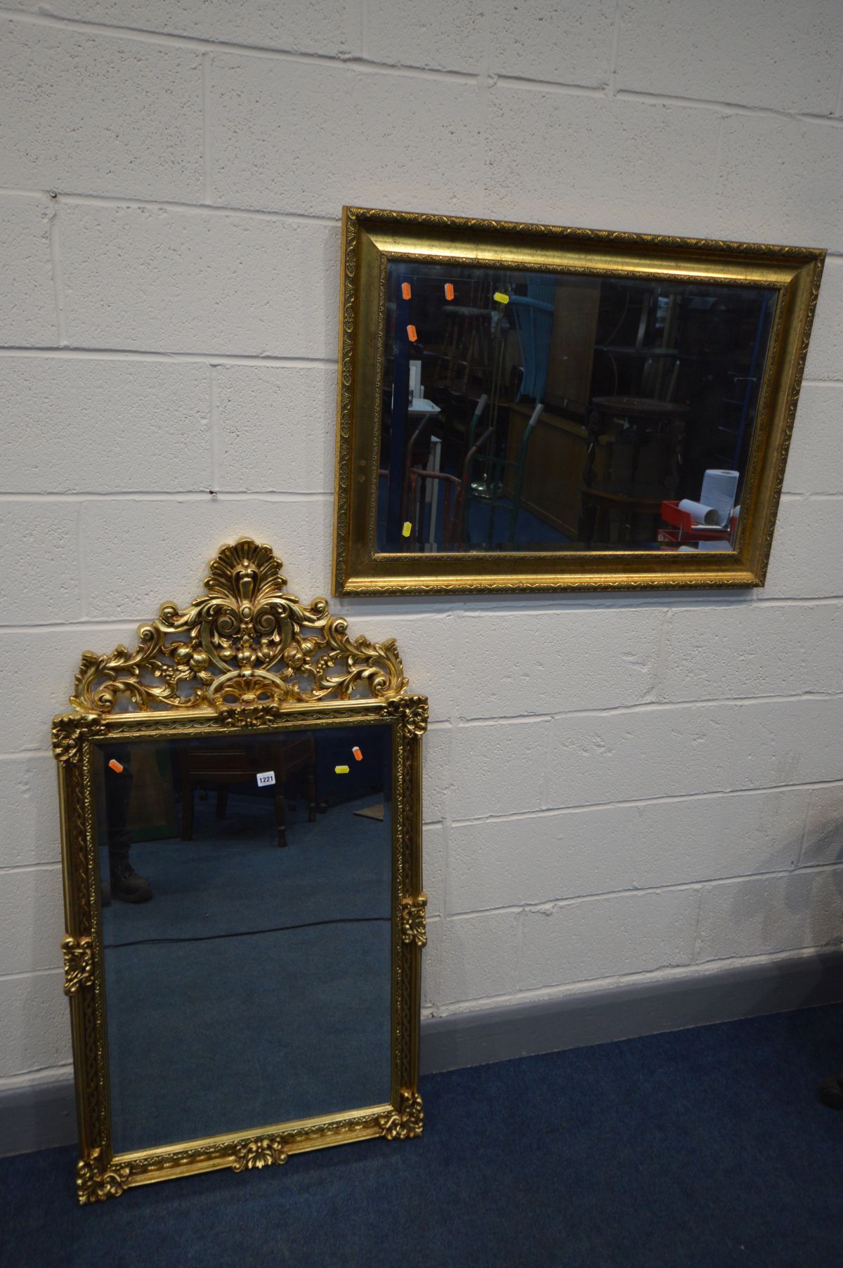 A GILT ON RESIN BEVELLED EDGE WALL MIRROR with open foliate, 67cm x 124cm, together with a