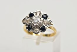 AN 18CT GOLD DIAMOND AND SAPPHIRE CLUSTER RING, the central brilliant cut diamond within a collet