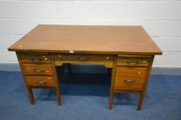 A MID 20TH CENTURY TEAK EFFECT OFFICE DESK with an assortment of drawers, width 137cm x depth 77cm x