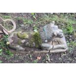 A GARDEN FIGURE OF A RECUMBANT LION on a rectangular base (one piece) with a clean break to base and