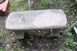 A COMPOSITE GARDEN BENCH with a top with detailed edges above two scrolled bases (some metal