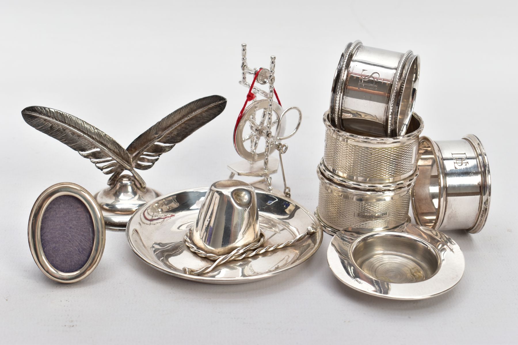 A COLLECTION OF SILVER AND WHITE METAL ITEMS, to include four hallmarked silver napkin rings, two of