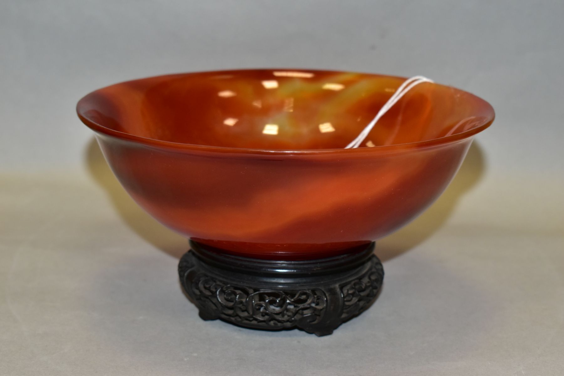 A CHINESE AGATE BOWL, semi translucent striated amber tones, short circular foot, diameter 18.8cm,