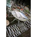 A LARGE PAINTED ALUMINIUM GARDEN TABLE with a pierced circular top 107cm in diameter, four metal and