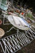 A LARGE PAINTED ALUMINIUM GARDEN TABLE with a pierced circular top 107cm in diameter, four metal and