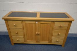 A MODERN SOLID OAK SIDEBOARD with double granite inserts, two banks of three drawers flanking double