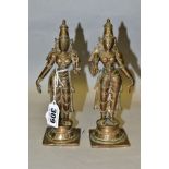 A NEAR PAIR OF BRONZE FIGURES OF PARVATI HOLDING A LOTUS FLOWER, cast on a circular plinth with
