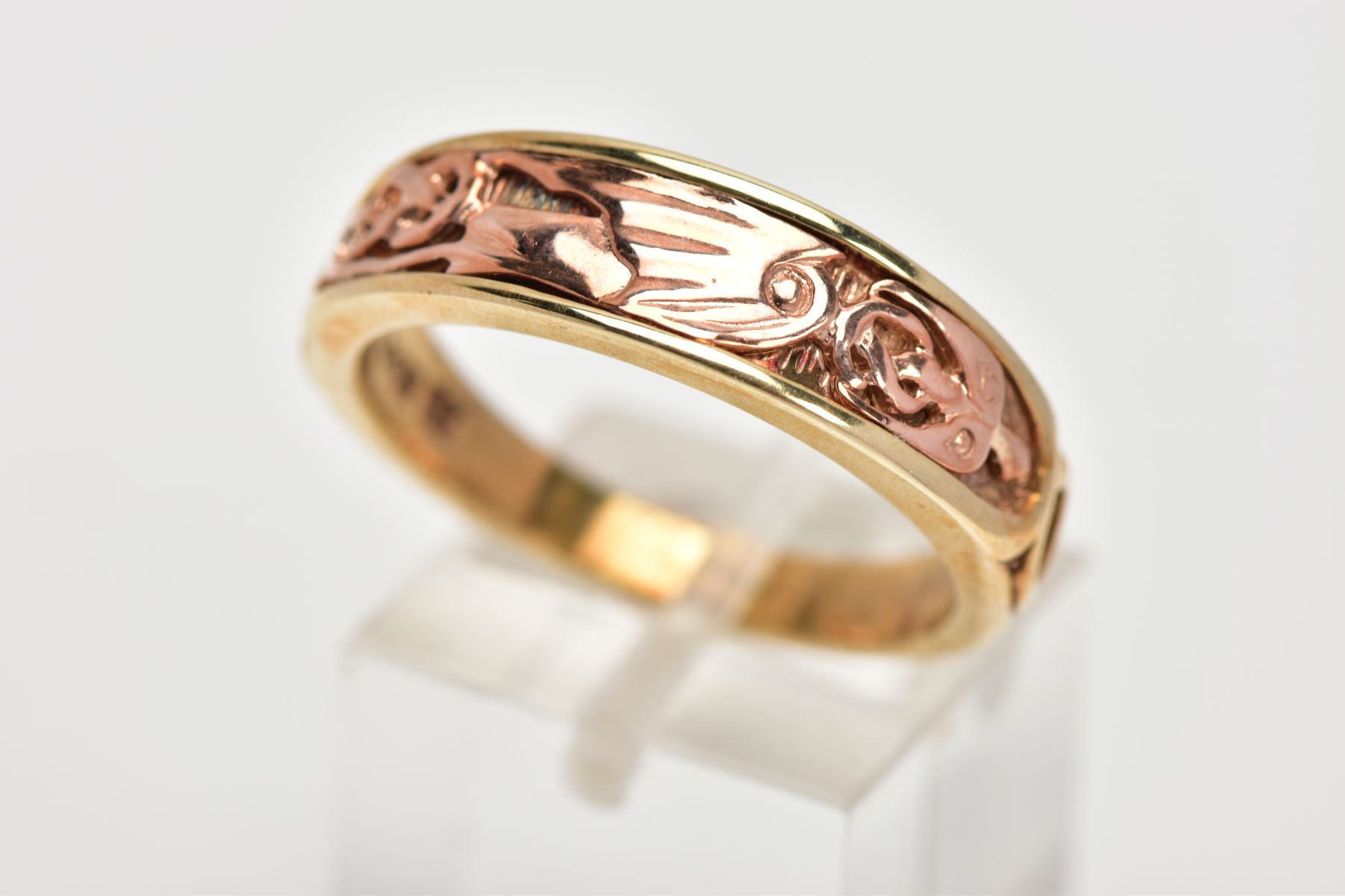 A 9CT GOLD BI-COLOUR CLOGAU RING, the rose gold 'Dragon's Wing' design applied to the tapered yellow