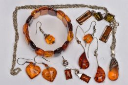 A SELECTION OF MAINLY CLARIFIED AMBER JEWELLERY, including an elasticated panel bracelet, a pair