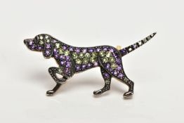 A GEM SET DOG BROOCH, designed as a pointer dog, set with circular peridots and amethysts to the