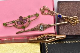 FOUR YELLOW METAL GEM SET BROOCHES, to include a ruby set openwork brooch stamped '585', together