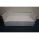 A MODERN WHITE PAINTED PULL OUT DAY BED, raised back and sides, three drawers to base, single