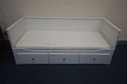 A MODERN WHITE PAINTED PULL OUT DAY BED, raised back and sides, three drawers to base, single
