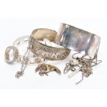 A SELECTION OF SILVER AND WHITE METAL JEWELLERY, to include three torque bangles, a rope twist