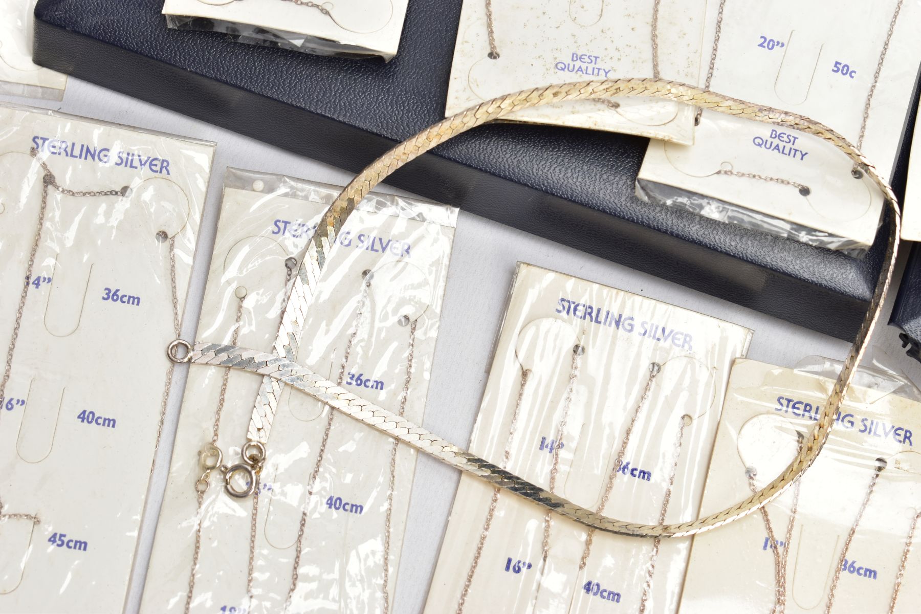 A SELECTION OF PACKAGED CHAINS, FLAT HERINGBONE CHAIN AND A CHARM BRACELET, the bracelet with four - Image 5 of 5
