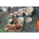 EIGHT GLAZED GARDEN POTS including a graduating set of four and four terracotta plant pots (12)