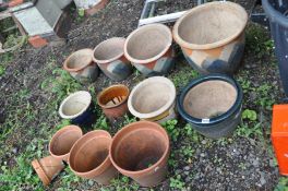 EIGHT GLAZED GARDEN POTS including a graduating set of four and four terracotta plant pots (12)