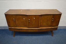A BEAUTILITY WALNUT SIDEBOARD, with central pull out drinks section flanked by double cupboard