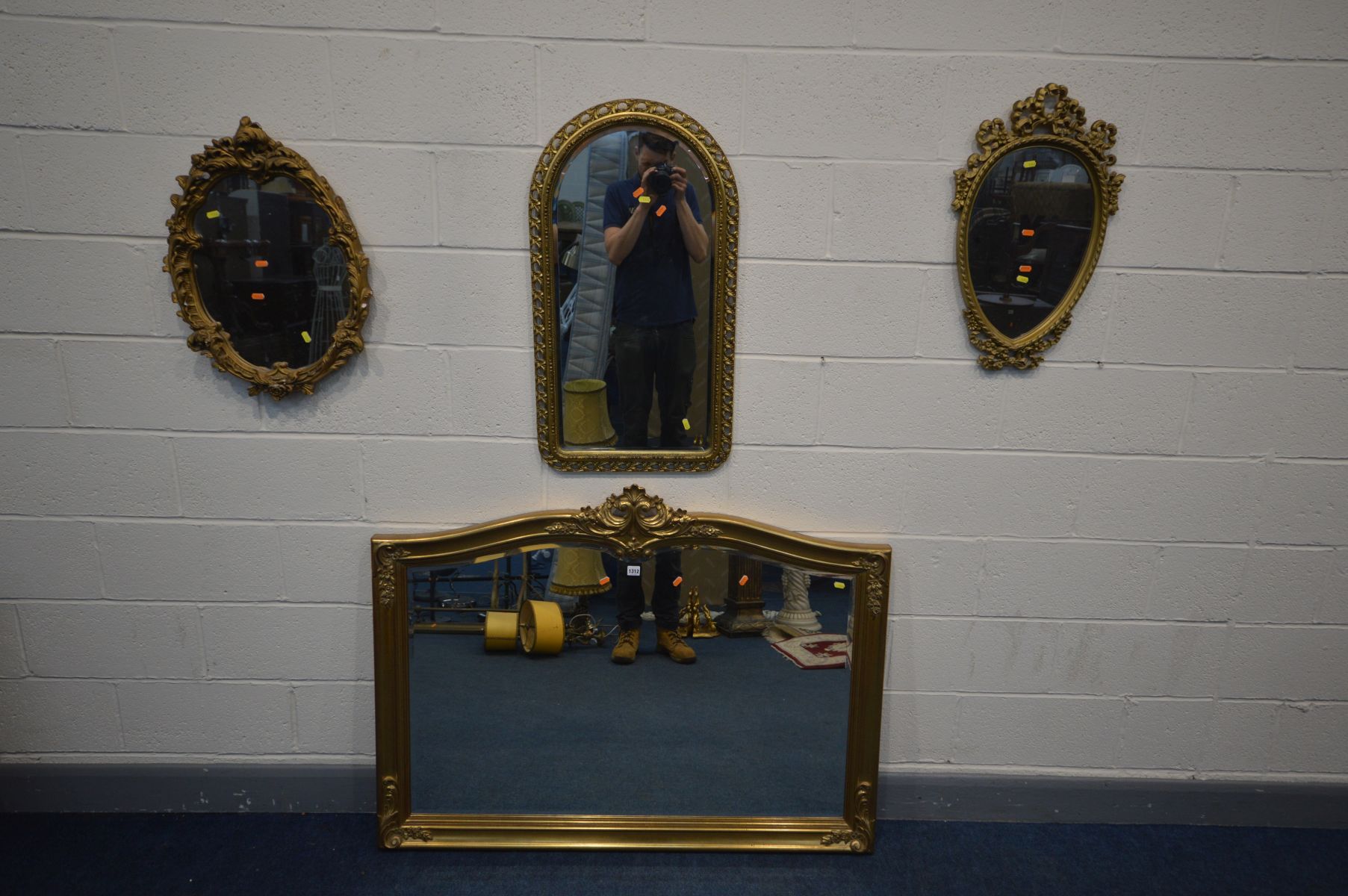 FOUR GILT FRAMED WALL MIRRORS to include a large giltwood bevel edged mirror, 130cm x 99cm, oval