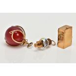 THREE 9CT GOLD CHARMS, to include a carnelian bead charm with a scalloped wire mount, a lantern