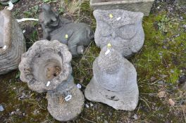 FOUR COMPOSITE GARDEN FIGURES comprising of a Budha, an owl, a recumbent elephant calf and a boot
