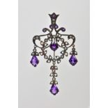 AN OPENWORK GEM PENDANT, the central wreath design with outer scrolling and foliate detail, set with