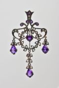 AN OPENWORK GEM PENDANT, the central wreath design with outer scrolling and foliate detail, set with