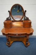 A VICTORIAN MAHOGANY DUCHESS DRESSING TABLE, oval swing mirror flanked by two scrolled supports,