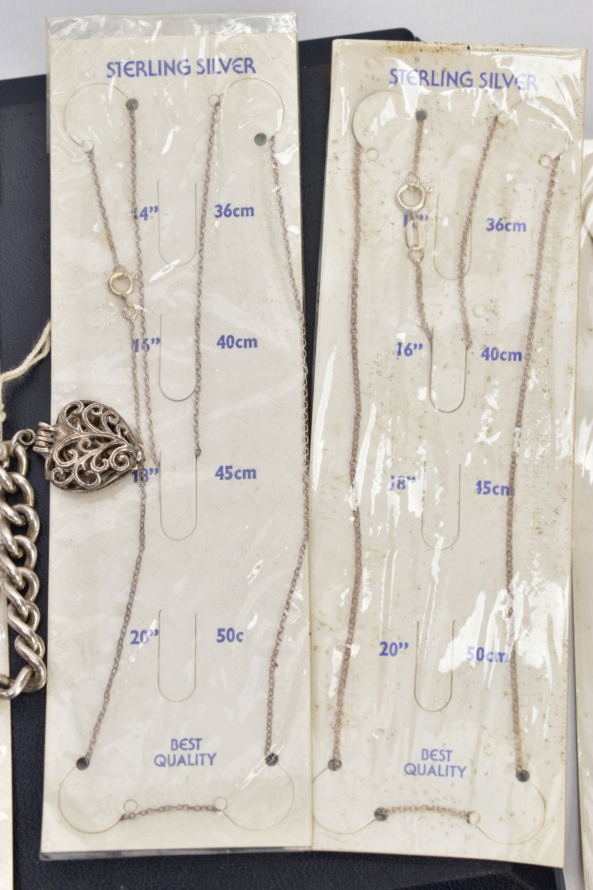 A SELECTION OF PACKAGED CHAINS, FLAT HERINGBONE CHAIN AND A CHARM BRACELET, the bracelet with four - Image 2 of 5