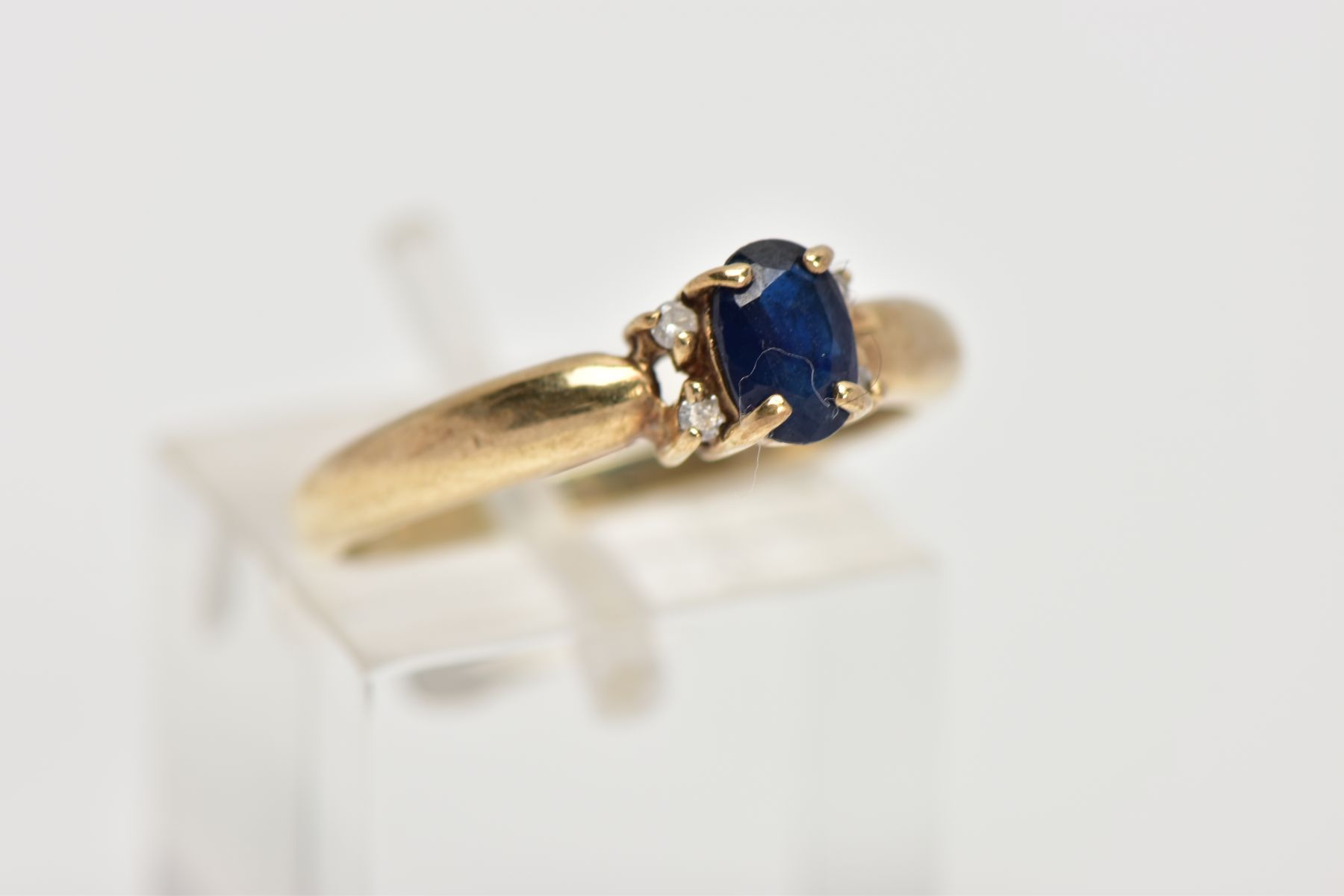 A 9CT GOLD SAPPHIRE AND DIAMOND RING, centring on an oval cut blue sapphire, flanked with four round - Image 4 of 4