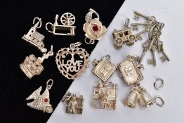 A SELECTION OF CHARMS, to include two hinged bibles, a hinged church, a set of keys, two piano