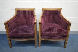 A PAIR OF HARDWOOD FRAMED TUB CHAIRS, covered with purple upholstery