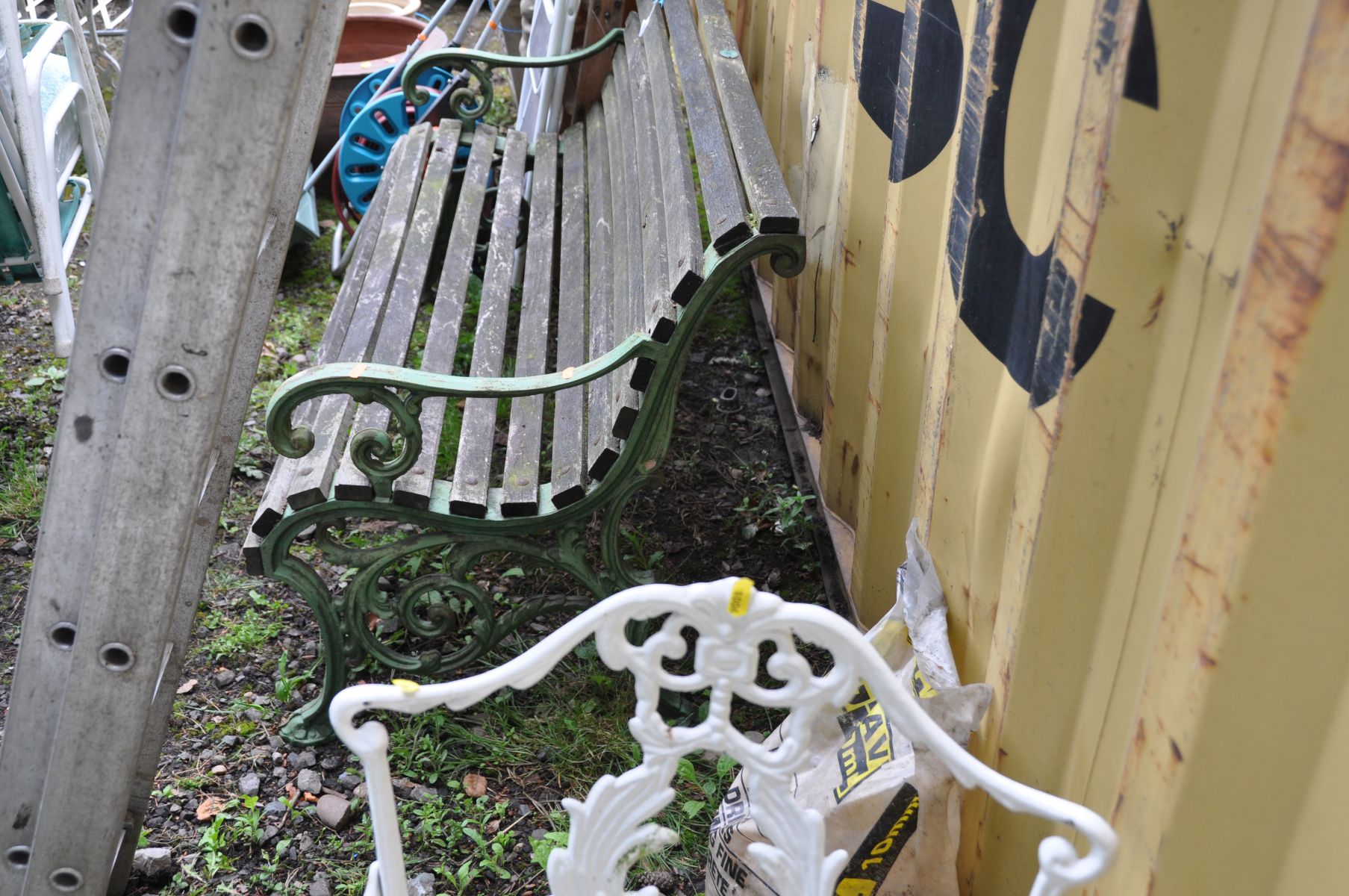 A GARDEN BENCH with cast iron ends with scrolled detailing and hardwood slats 145cm wide - Image 2 of 2