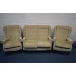 A BEIGE UPHOLSTERED WINGED BACK THREE PIECE SUITE, comprising a sofa and a pair of armchairs