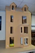 A PART COMPLETED WOODEN DOLLS HOUSE, modelled as a four storey Victorian/Edwardian villa, front