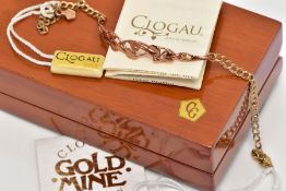 A 9CT GOLD BI-COLOUR CLOGAU BRACELET, the central panel of openwork 'Tree of Life' design in rose