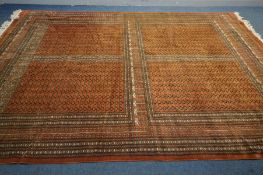 A WOLLEN RUSSET GROUND RUG, with a multi-strap border, 275cm x 365cm