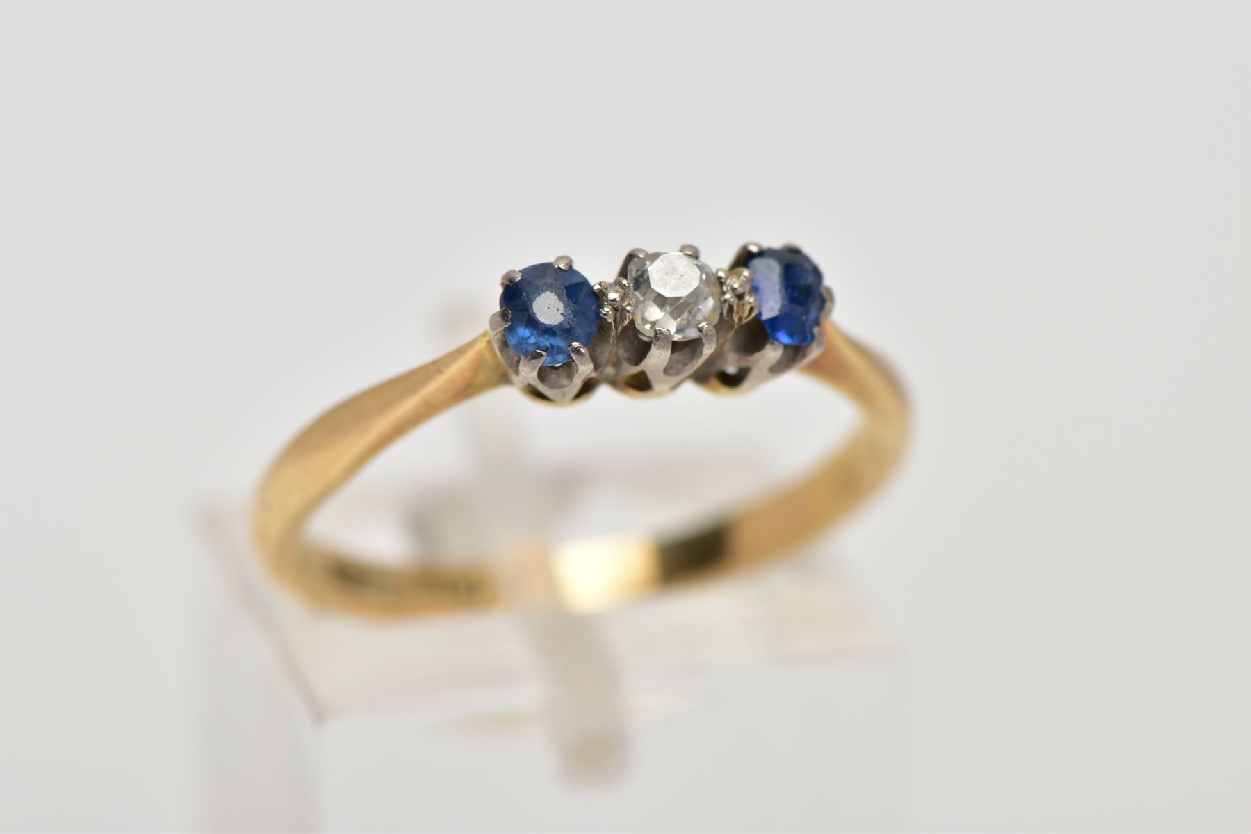 A YELLOW METAL THREE STONE RING, designed with a central, claw set old cut diamond, flanked with - Image 4 of 4