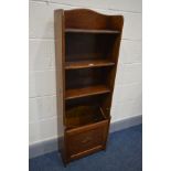 A SLIM EARLY TO MID 20TH CENTURY OAK OPEN BOOKCASE, with a fall front magazine rack, width 44cm x