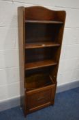A SLIM EARLY TO MID 20TH CENTURY OAK OPEN BOOKCASE, with a fall front magazine rack, width 44cm x