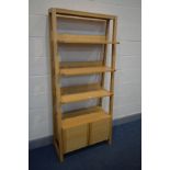 A MODERN LIGHT WOOD WATERFALL OPEN BOOKCASE, three open shelves above double cupboard doors, width