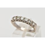 A WHITE METAL DIAMOND HALF ETERNITY RING, designed with a row of claw set round brilliant cut