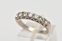 A WHITE METAL DIAMOND HALF ETERNITY RING, designed with a row of claw set round brilliant cut