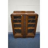 AN EARLY TO MID 20TH CENTURY OAK ASTRAGAL GLAZED TWO DOOR BOOKCASE, enclosing three adjustable