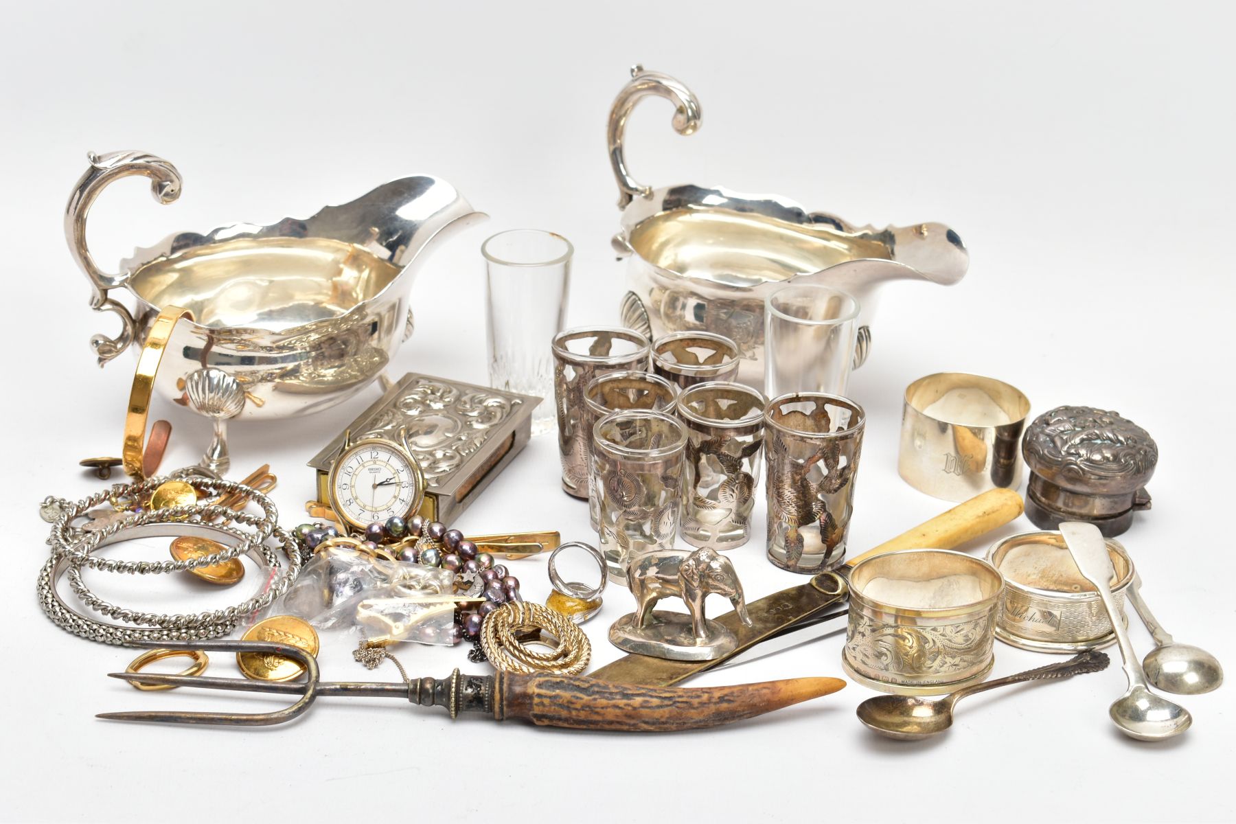 A BOX OF SILVER AND OTHER METALWARE, to include three hallmarked napkin rings, a silver cap for a